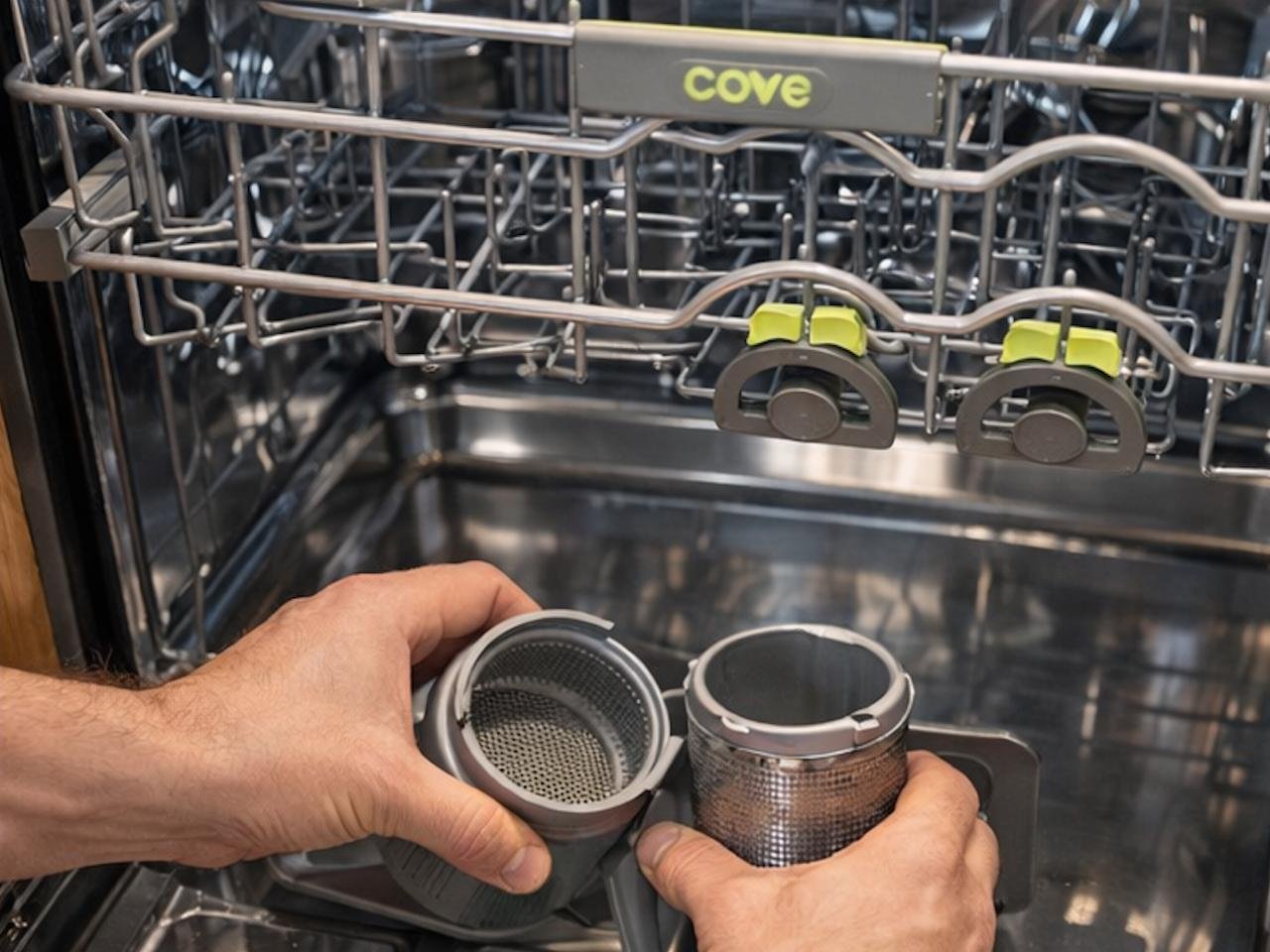 Deep cleaning and maintenance of the multi-stage filtration system in a luxury Cove dishwasher.